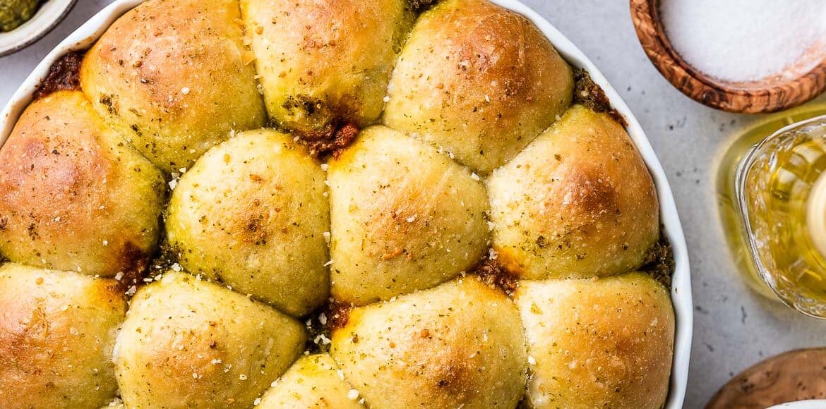 Pesto Bread/Pull-Apart Rolls in a white baking dish.