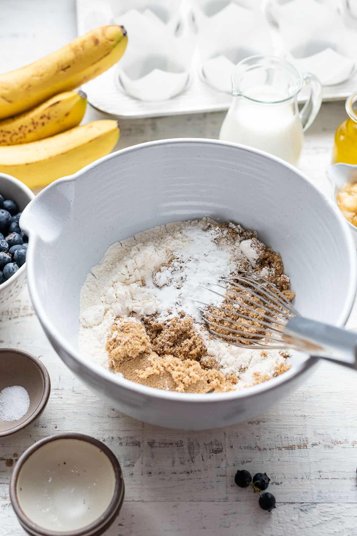 Dry ingredients for Blueberry Banana Muffins in a bowl.